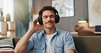 Relax, music and man with headphones in home for streaming service, hip hop playlist or podcast. Technology, sofa and happy person listening to audiobook, song or audio with sound on weekend to chill