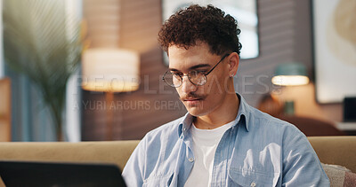 Buy stock photo Remote work, man and laptop in home for reading, email draft or creative writing on sofa. Freelance writer, tech or connectivity in living room for article editing, story research or publication