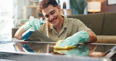 Buy stock photo Happy man, spray bottle and table with detergent for cleaning service or housekeeping at home. Male person, maid or cleaner with smile, gloves or cloth for bacteria or germ removal on glass surface