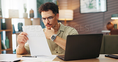Buy stock photo Business, documents and laptop with man in home office for startup planning or research. Computer, reading and remote work with freelance employee at desk in apartment for review of information