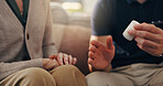 Hands, old woman and caregiver with pills on sofa for illness management, prescription drugs or explain dosage. Homecare, patient and healthcare worker with medication discussion for health treatment