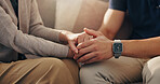 Senior, person and holding hands with caregiver on sofa for empathy, retirement support and compassion. Closeup, patient and health worker in assisted living with comfort and console for medical news