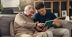 Old man, nurse and tablet on couch, happy and help for streaming movie with point at apartment. Caregiver, elderly person and touchscreen for film, app and subscription with laugh in retirement home
