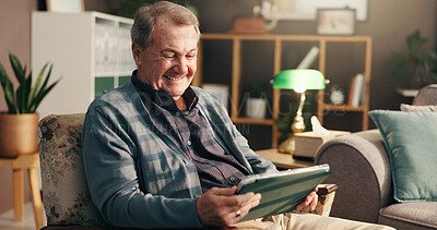 Buy stock photo Senior man, tablet and laugh on sofa, relax and happy with streaming, movie and comedy show on web in home. Elderly person, touchscreen and scroll for funny film, app and smile on couch in retirement