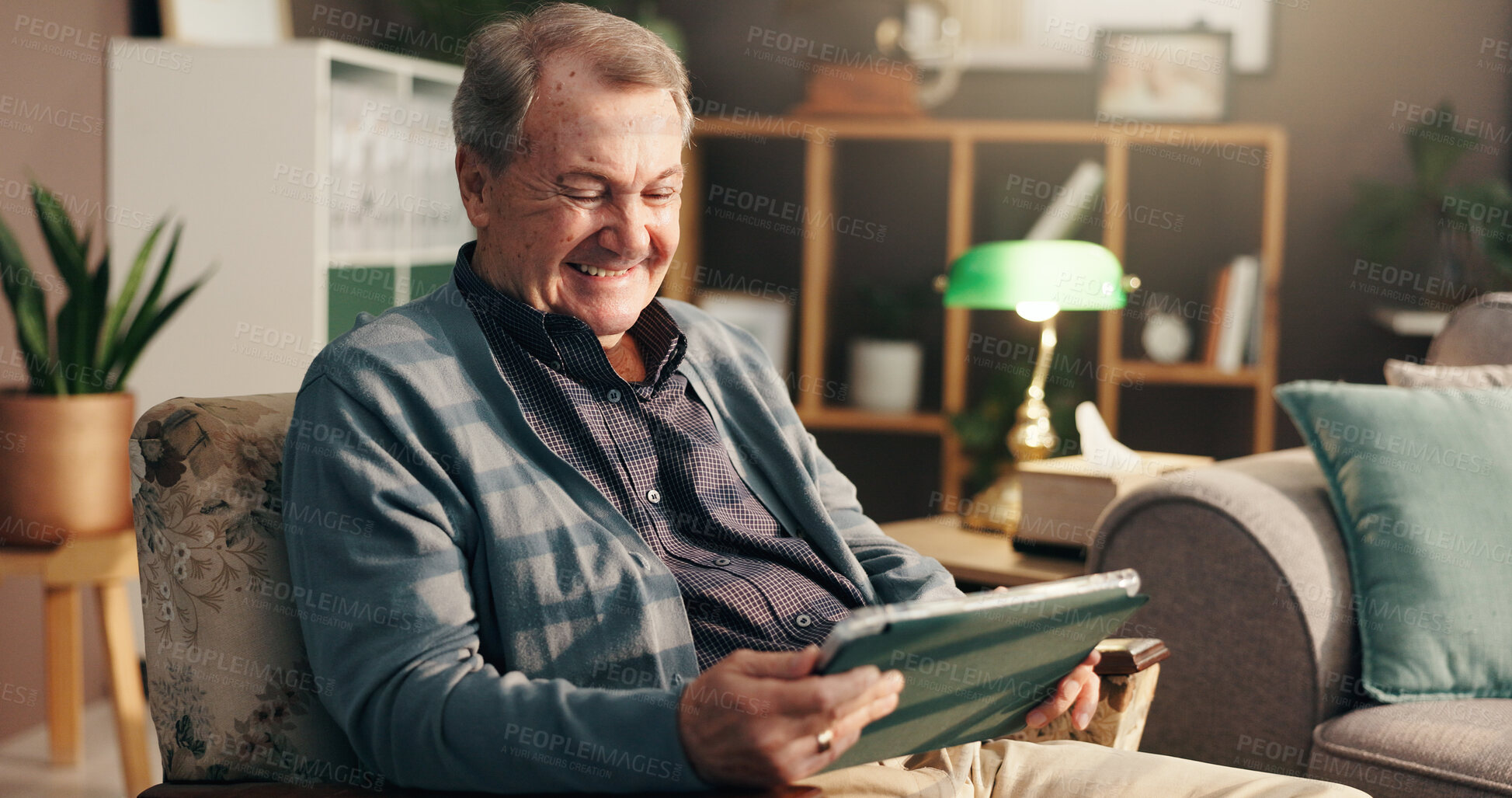 Buy stock photo Senior man, tablet and laugh on sofa, relax and happy with streaming, movie and comedy show on web in home. Elderly person, touchscreen and scroll for funny film, app and smile on couch in retirement
