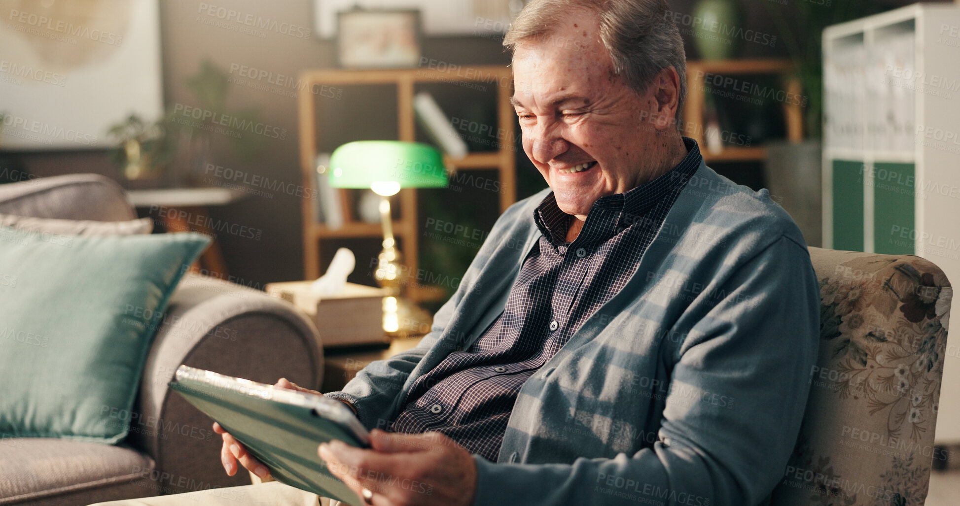 Buy stock photo Senior man, tablet and laugh on couch, relax and happy with streaming, movie and comedy show on web in home. Elderly person, touchscreen and app for funny film, social network and smile in retirement