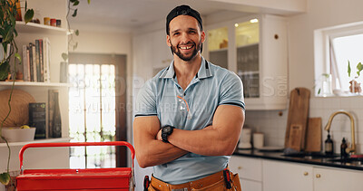 Buy stock photo Plumber, arms crossed and portrait of man in kitchen for maintenance, house renovation and drainage repairman. Handyman, toolbox and pipe inspection with person in home for diy, labor and upgrade