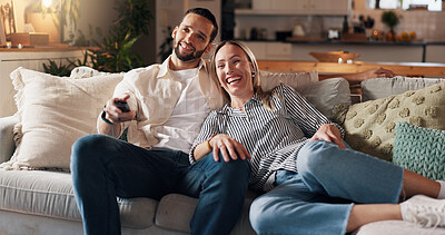 Buy stock photo Couple, relax and watching tv on sofa, laugh and home with funny film, love and bonding in lounge. People, woman and man with remote control on couch for movies, comedy or subscription in living room