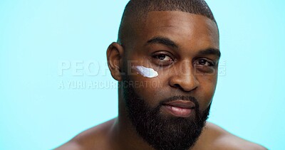 Buy stock photo Portrait, cream and black man with cosmetics, skincare and dermatology on blue studio background. African person, space and model with shine, creme and glow with moisturiser, beauty and facial spf