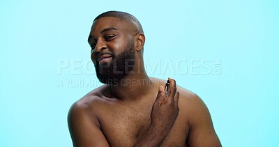 Buy stock photo Black man, spray or cologne for hygiene in studio, fragrance or grooming with cosmetic product on blue background. Smell, perfume or spritz for scent, male person and self care with wellness space