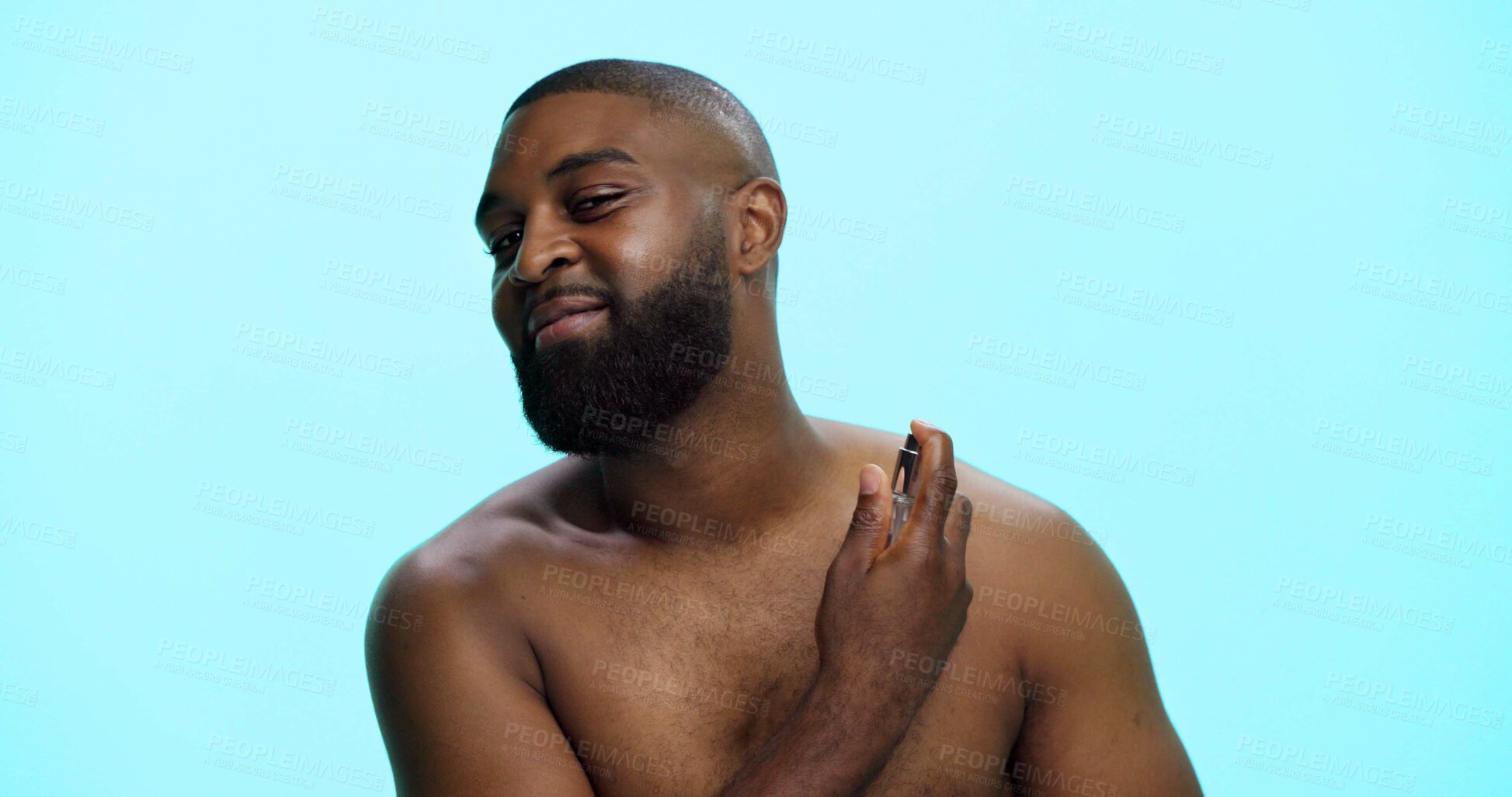 Buy stock photo Black man, spray or cologne for hygiene in studio, fragrance or grooming with cosmetic product on blue background. Smell, perfume or spritz for scent, male person and self care with wellness space