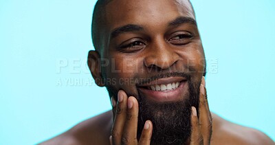 Buy stock photo Face, black man and beard with smile for beauty, haircare wellness and cosmetics on blue background. Facial hair, self care and healthy glow with male person in studio, dermatology and grooming