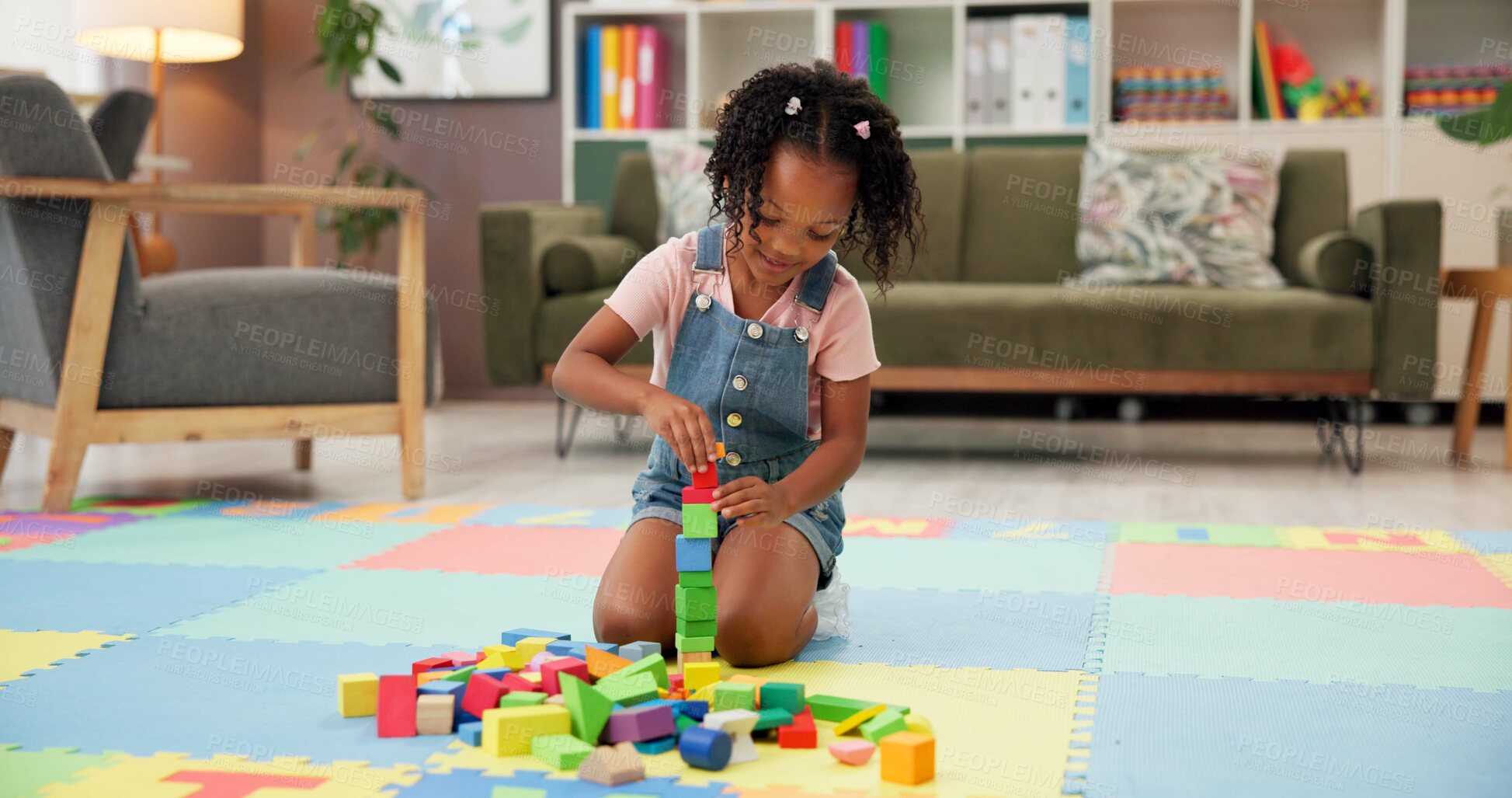 Buy stock photo Child, block and building with toys for fun activity or playing on floor at elementary school. Black girl, kid or student with shapes for playful learning, fine motor skills or education in classroom
