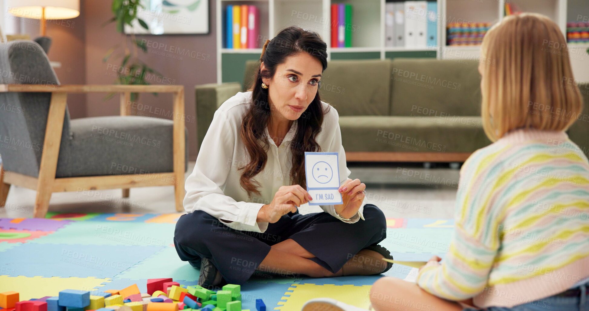 Buy stock photo Woman, girl and card with psychology for emotion, choice or sad emoji for mental health assessment on floor. Paper, therapist and child with sign for feelings, icon and evaluation with test at clinic