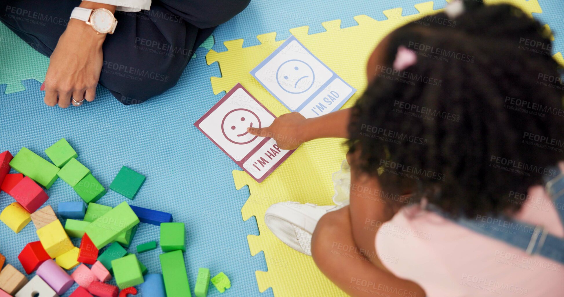 Buy stock photo Hands, child and card with therapy for emotion, choice and happy emoji for mental health assessment on floor. Paper, psychologist and kid with decision for feelings, above and evaluation at clinic
