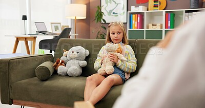 Buy stock photo Psychology, girl and doll on sofa with talk, question or communication for emotional assessment at clinic. Person, therapist and child with plush toys, evaluation and test for mental health on couch