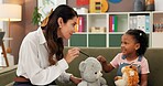 Therapist, child and toys in office for therapy session, mental health and learning. Psychologist woman, story and girl for evaluation, clinic or consultation for patient support or development