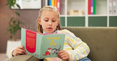 Buy stock photo Girl, reading and sofa with book for learning, education or lesson at private elementary school. Child, kid or student with novel on couch for early childhood development, knowledge or story time