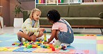Building blocks, fun and children in psychology waiting room with cognitive development or growth. Friends, creative and girl kids playing with educational toys for sensory or motor skills at clinic.