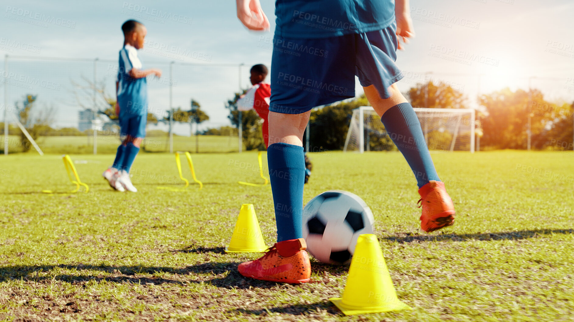 Buy stock photo Sports field, legs and children with ball, energy and athlete with coach for practice in morning and cardio. Outdoor, football and kids with sportswear for game, growth and development with fitness
