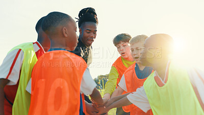 Buy stock photo Hands together, soccer and coach in huddle with children on field for motivation, game plan and strategy. Competition, training and practice with kids outdoor for sports, football player and support