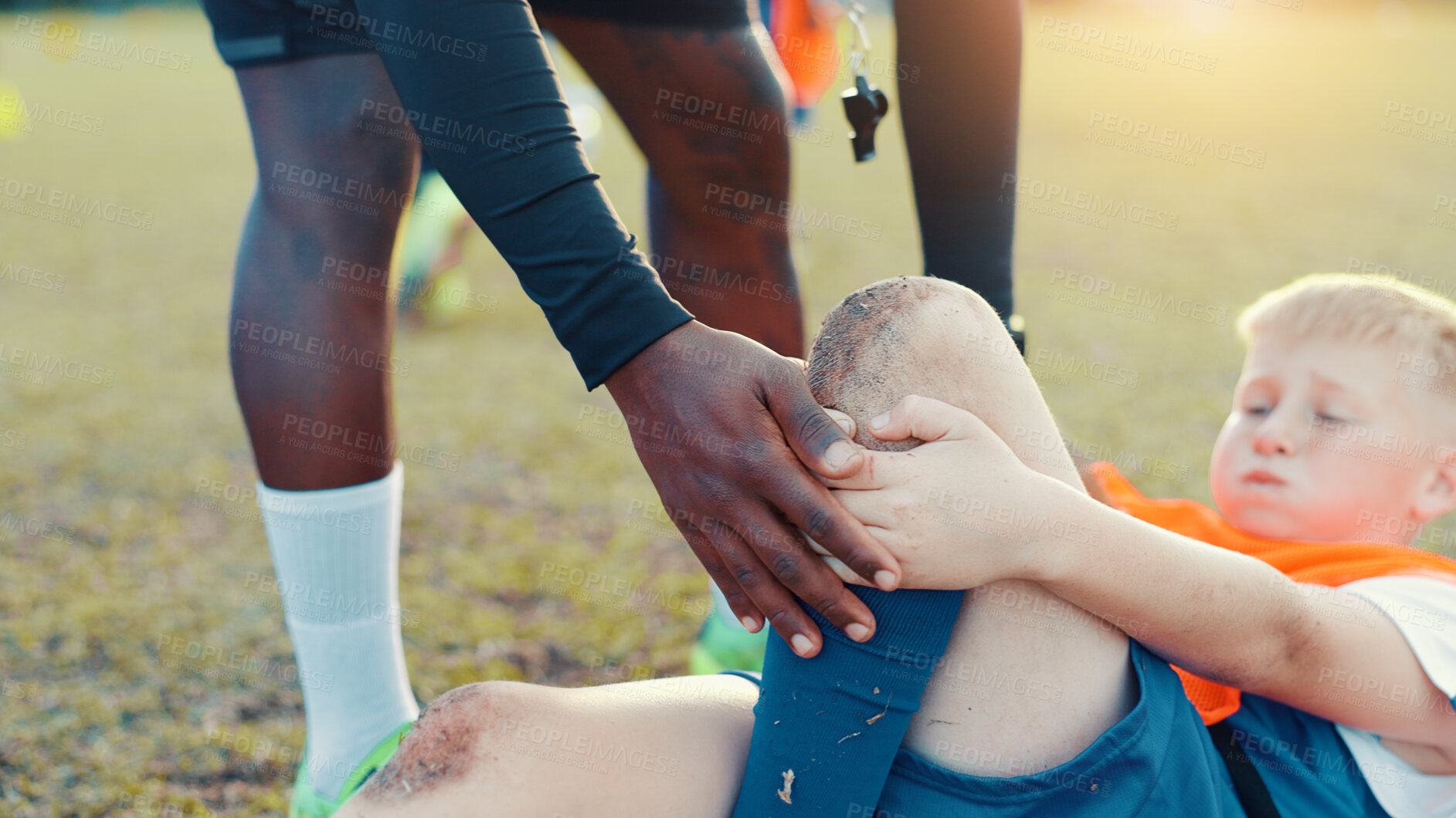 Buy stock photo Soccer, child and knee pain for injury, accident and muscle tension during kick in sports competition. Football field, hands and coach with boy for helping, support and tendinitis emergency for kid