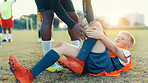 Soccer, child and player for injury, knee pain and muscle tension for scrape in sports competition. Football field, hands and coach with boy for helping, support and tendinitis emergency for kid
