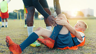 Buy stock photo Soccer, child and player for injury, knee pain and muscle tension for scrape in sports competition. Football field, hands and coach with boy for helping, support and tendinitis emergency for kid
