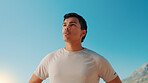 Man, fitness and breathing with blue sky in nature for workout break, rest or exercise. Active, male person or runner with recovery or fresh air for outdoor cardio training, health and wellness