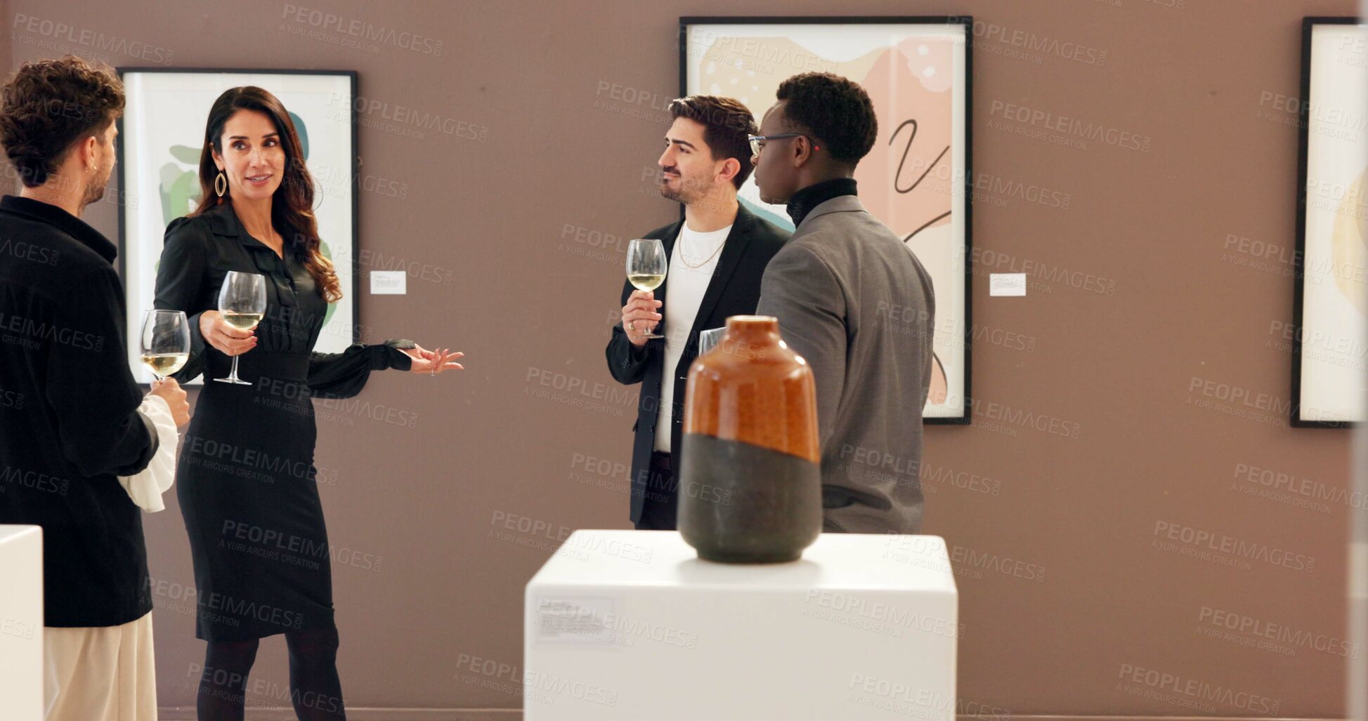 Buy stock photo People, art and talking with champagne at gallery for event, audience chat and sculpture auction. Men, woman and wine glass for discussion, artwork collection and explaining negotiation of exhibition
