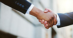 Closeup, business people and men in city, handshake and partnership with b2b deal. Greeting, contract and outdoor with introduction, shaking hands and welcome with agreement, hello and investor