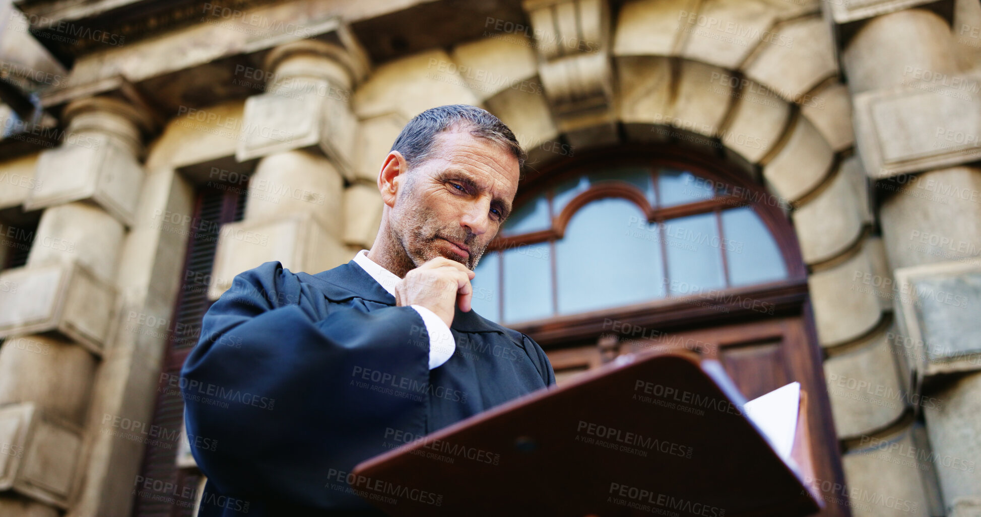 Buy stock photo Thinking, reading and judge and mature man in city for trial report, policy legislation and legal documents. Lawyer idea, attorney paperwork and vision with person at courtroom outdoor in low angle