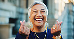 Portrait, woman and laughing with finger heart for love, care emoji and share kindness. Happy, mature person and romance hand gesture with care symbol, showing gratitude and affection shape in city

