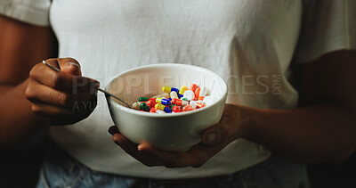Buy stock photo Hands, bowl and pills for addiction in studio with eating for mind altering drugs by black background. Person, capsule and illegal medicine with opioid crisis, mood and spoon with chemical compound