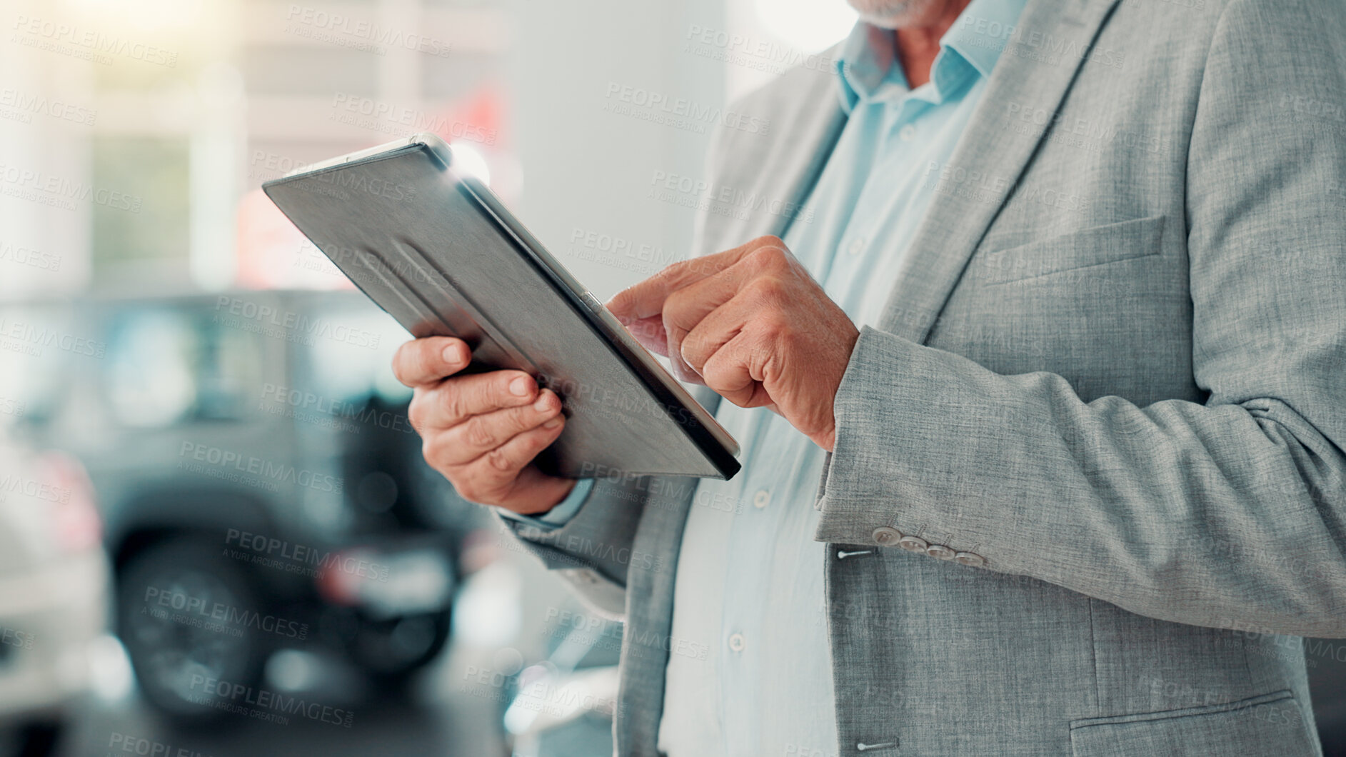 Buy stock photo Businessman, hands and scroll with tablet for dealership, reading and website for car rental service. Closeup, mature person and seller with digital for inventory information, vehicle shop and typing