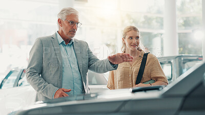 Buy stock photo People, customer and salesman with talking for car dealership, transport model and motor for rental service. Showroom, woman and mature seller with pitch for vehicle features, helping and discussion