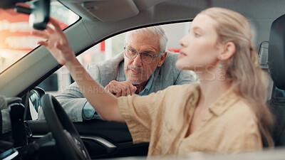Buy stock photo Salesman, woman and conversation by car at dealership with sale, negotiation and check mirror at shop. People, agent and inspection for test drive, purchase or guide for deal with vehicle at showroom