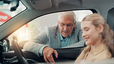 Buy stock photo Drive, customer and salesman with talking in car dealership, transport model and rental service. Showroom, woman and mature seller with pitch for vehicle features, assistance and discussion by flare