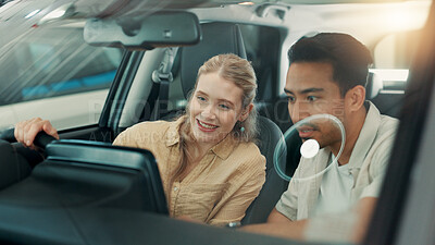 Buy stock photo Couple, talk and test drive at dealership for car, decision or smile with inspection in interior. People, man and woman with dashboard, excited or display with choice for vehicle purchase at showroom