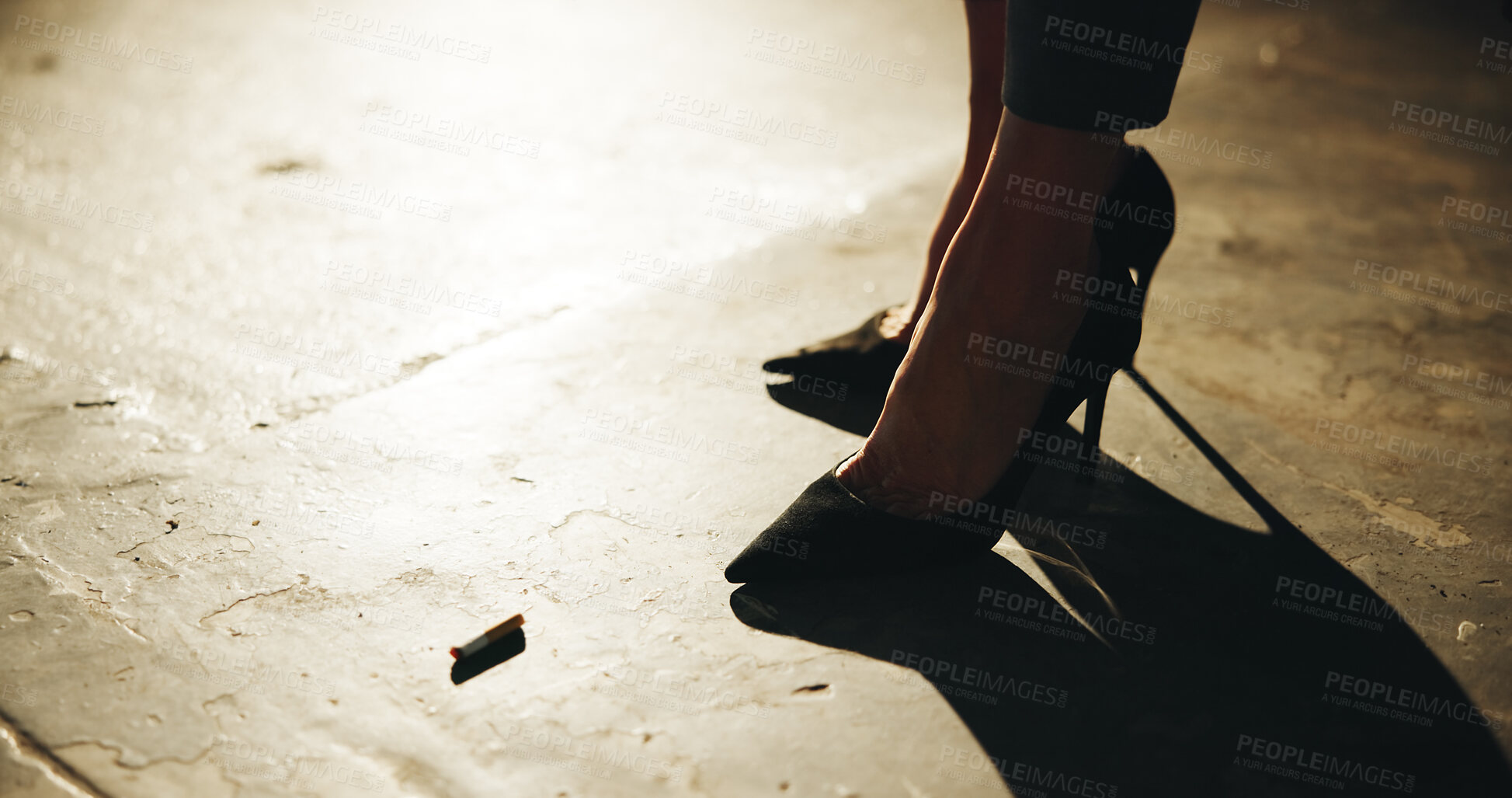 Buy stock photo Cigarette, high heels and shadow of woman on concrete for attitude or beating addiction in evening. Bud, nicotine and smoke with person in stilettos for end of tobacco habit on ground late at night