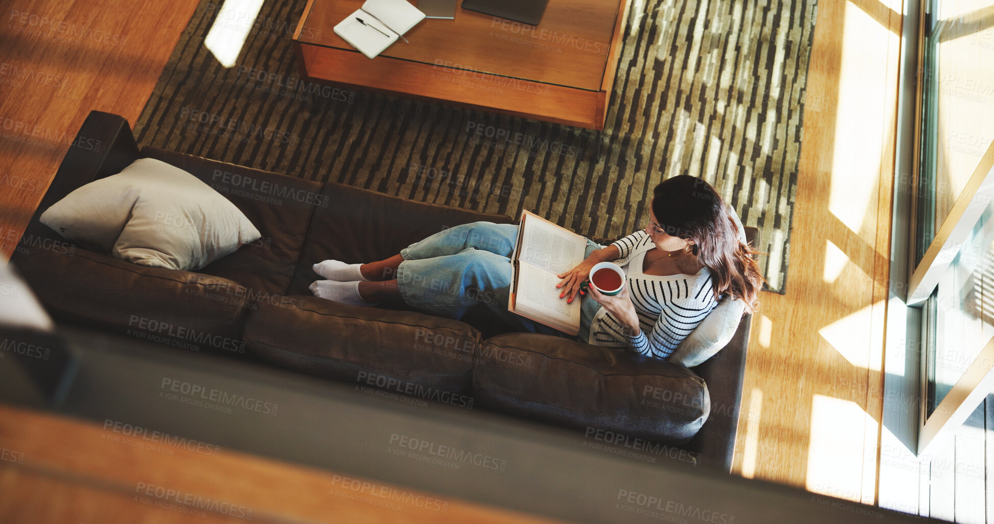 Buy stock photo Above, woman and reading book with tea at house for literature, fantasy novel and weekend break. Female person, relax and beverage with fiction story, information and knowledge of hobby entertainment