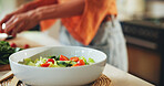 Home, person and cooking a salad bowl in kitchen for healthy dinner, organic recipe and nutrition. Closeup, meal preparation and vegetable ingredients for brunch cuisine, vegan food and fresh dish