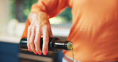 Buy stock photo Cooking, hand and olive oil with person in kitchen of home for food or meal preparation. Bottle, ingredients and recipe with chef pouring liquid closeup in apartment for diet, health or nutrition