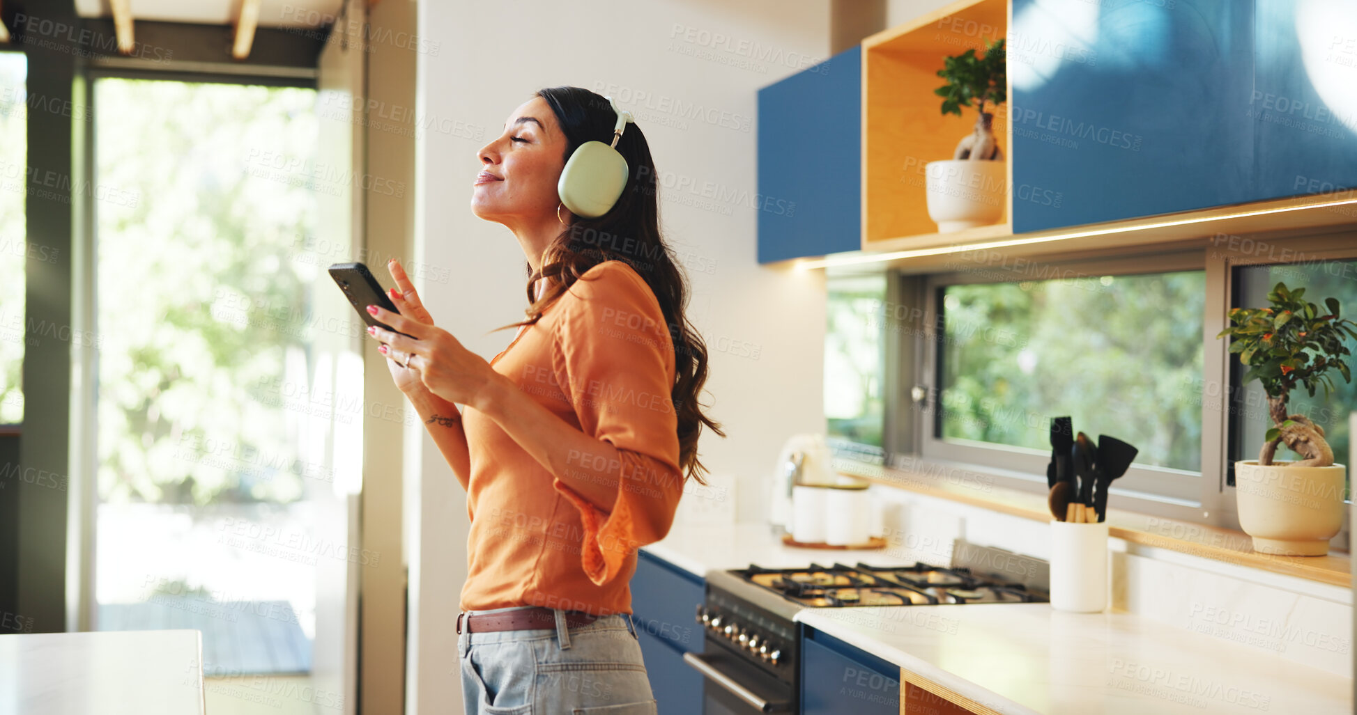 Buy stock photo Smile, music and phone with woman in kitchen for streaming, relax and entertainment. Sound app, happiness and radio with person listening with headphones in home for album, playlist and online song