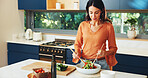 Cooking, salad and woman mix vegetable for healthy diet, nutrition or ingredients in home kitchen. Vegan, meal prep or person make lunch with leafy greens, natural tomato or organic food for wellness