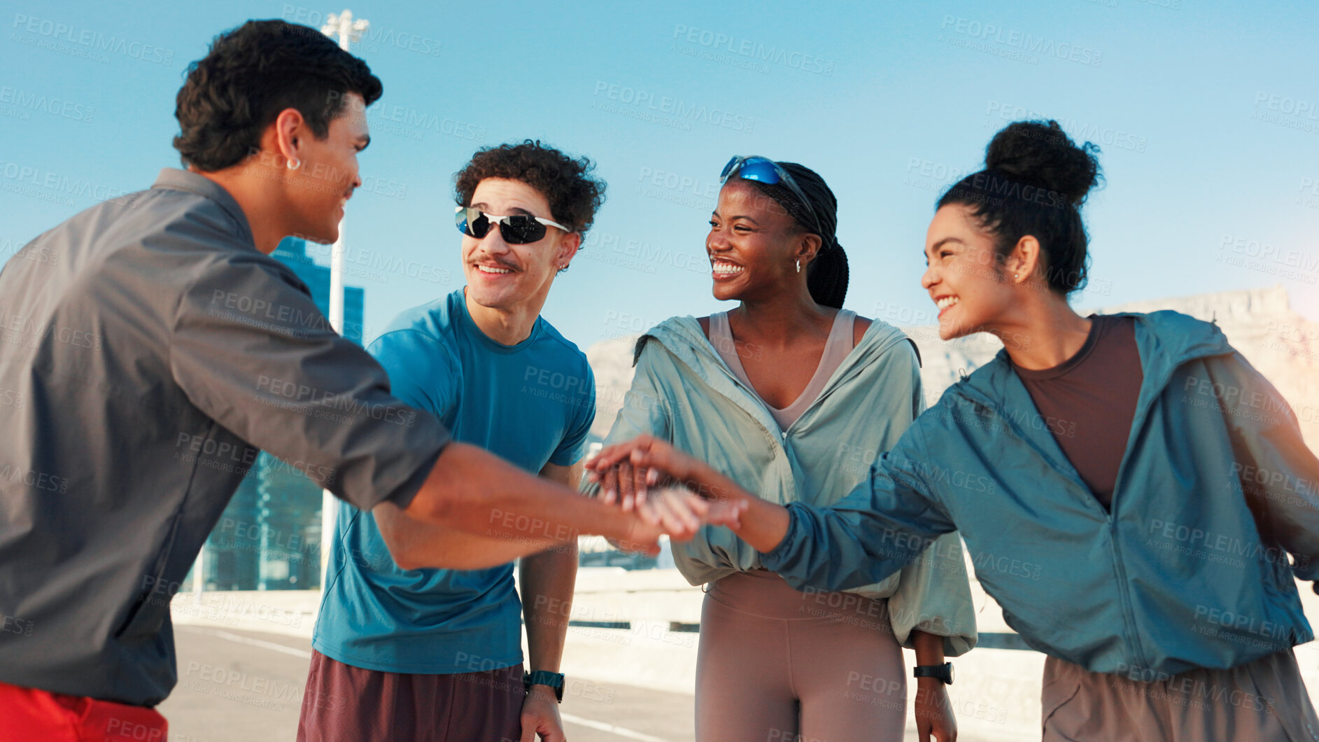 Buy stock photo Happy people, fitness or city with hands together for motivation, teamwork or unity. Active, group or friends piling with smile or stack in huddle for workout, exercise or health and wellness in town
