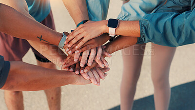 People, fitness and hands together with huddle in city for workout goals, motivation or mission. Closeup, active group or friends piling with stack above for team exercise or support in an urban town