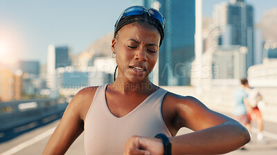Buy stock photo Tired woman, fitness and checking watch in city for workout, exercise or performance. Active, female person or exhausted runner with wristwatch for tracking app, calories or intense training in town