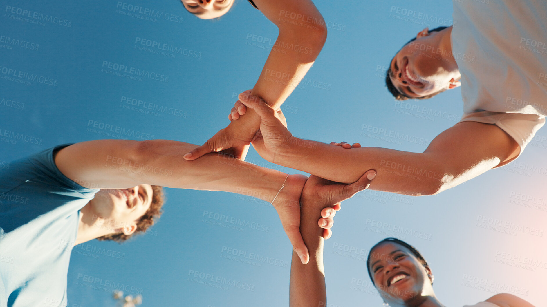 Buy stock photo Fitness, below and group holding hands for solidarity, collaboration or support outdoor with blue sky. Friends, people and community together for motivation, exercise goal and happy team with synergy
