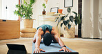 Man, tablet and stretching on yoga mat in home for muscle tension relief, morning exercise and online class. Fitness, pilates and person with video tutorial on floor for balasana pose and workout